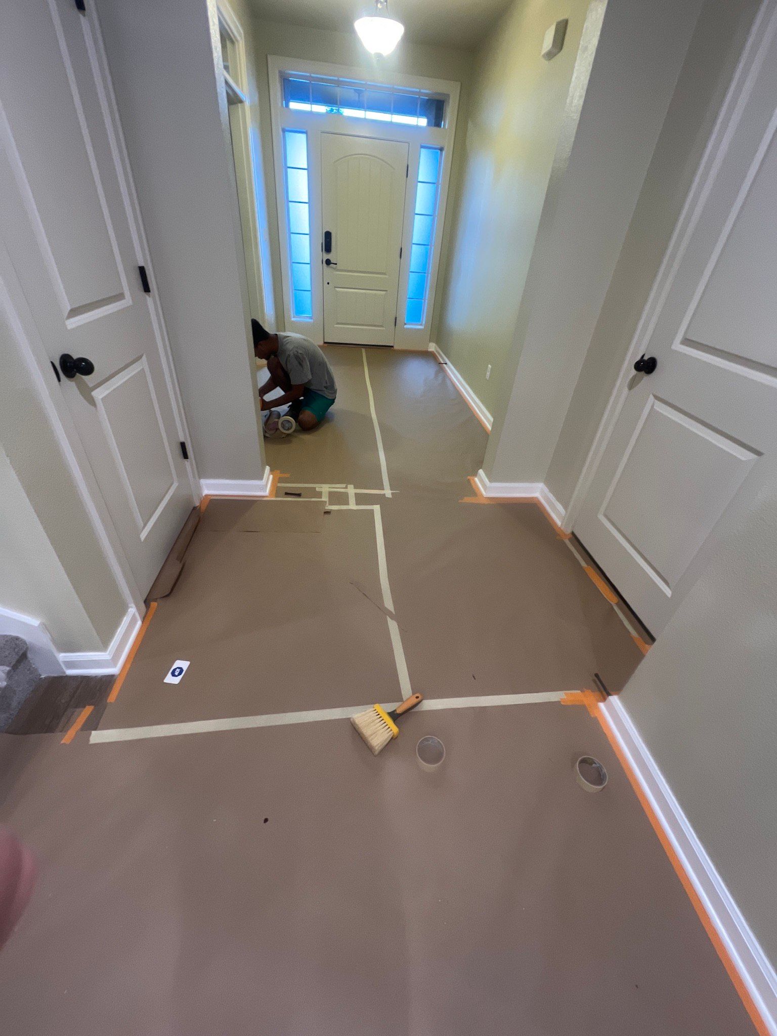 A hallway with a piece of tape on the floor.