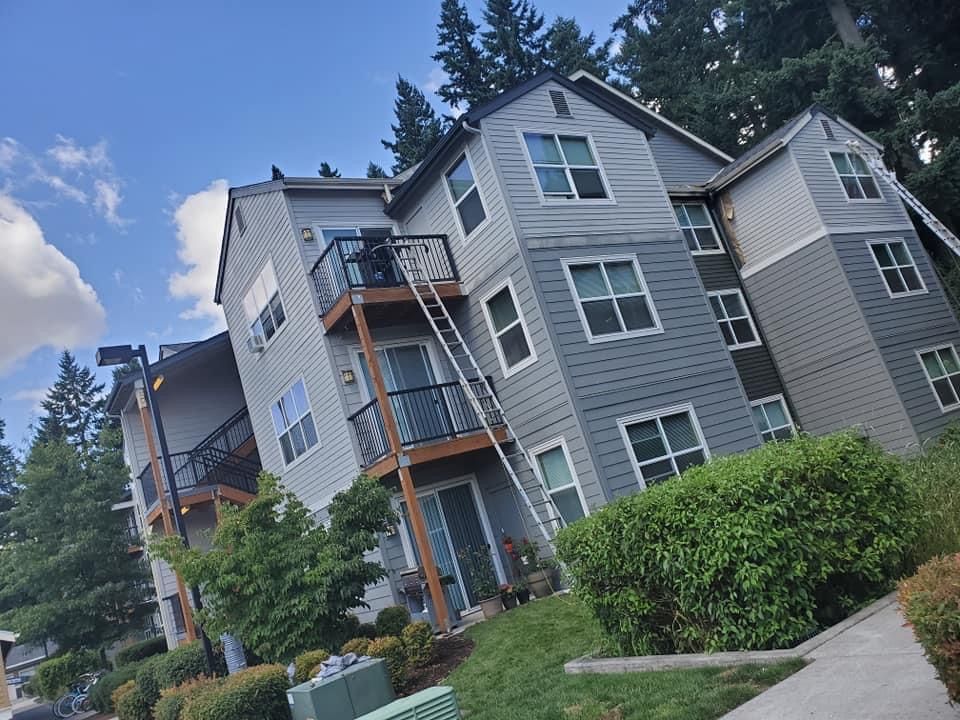 A man is painting the ceiling of a room.
