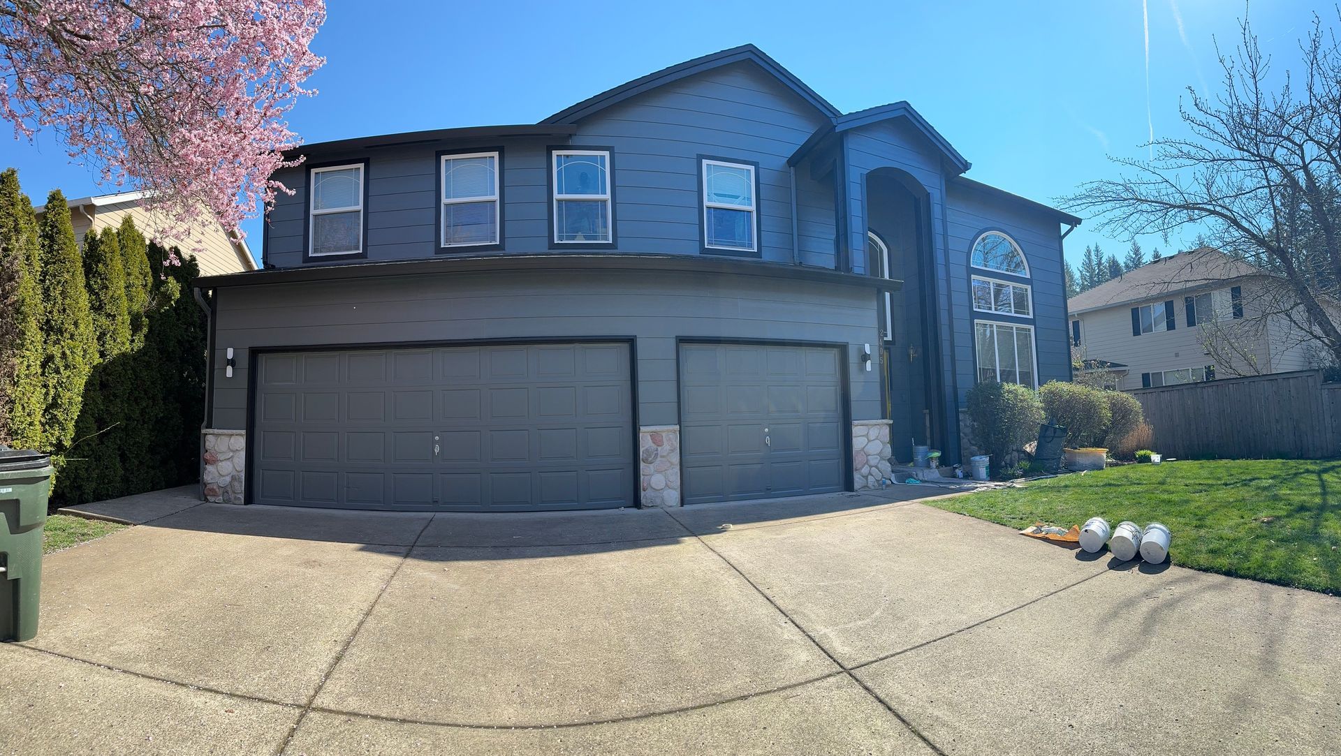 A large house with two garage doors and a large driveway