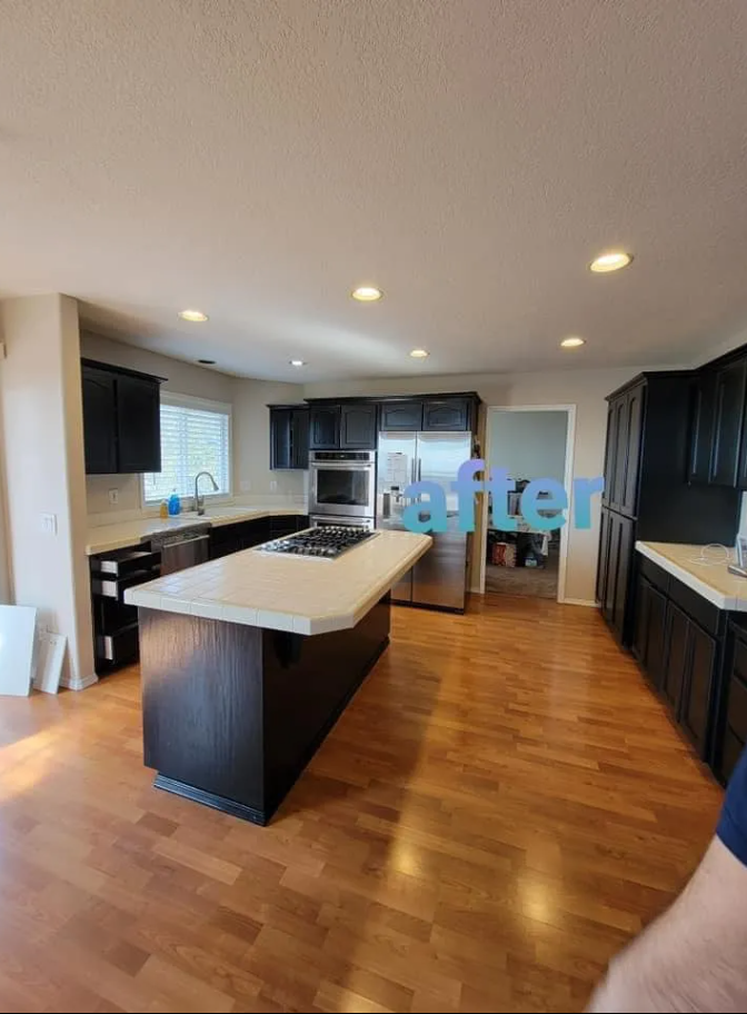 A kitchen with a large island and stainless steel appliances