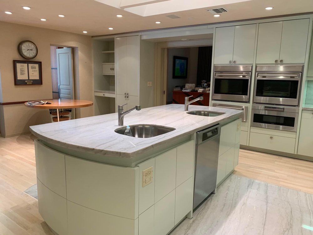 A kitchen with stainless steel appliances and a large island