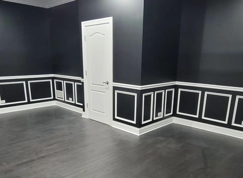 An empty living room with red walls and a vaulted ceiling.