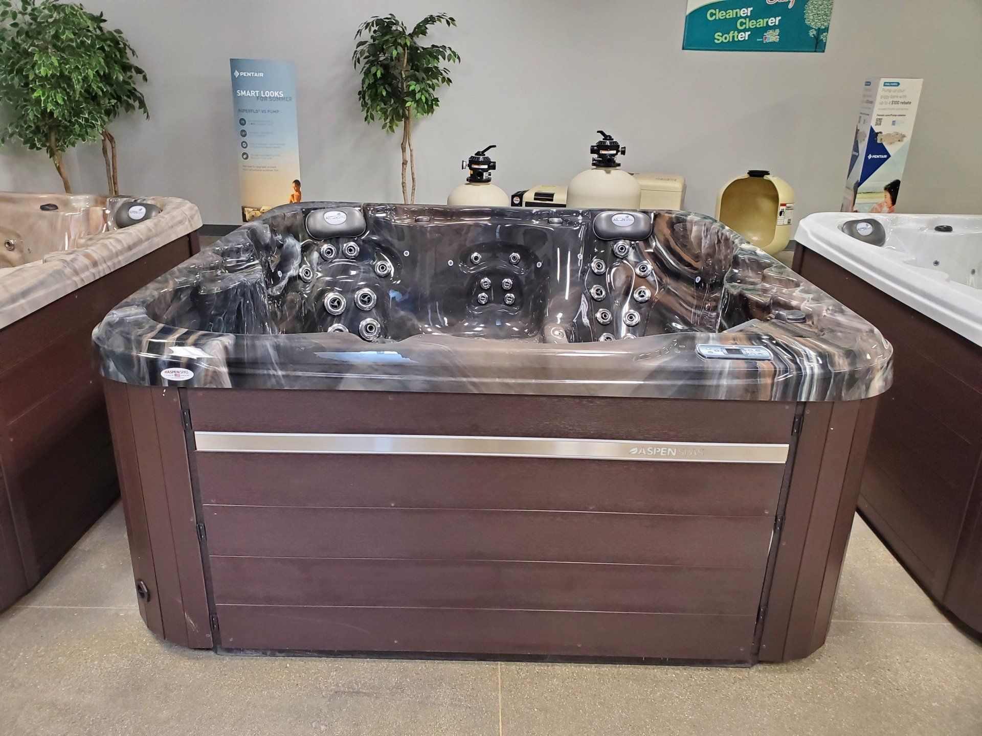 A large hot tub in a room with other hot tubs
