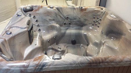 A hot tub is sitting on a table in a room.