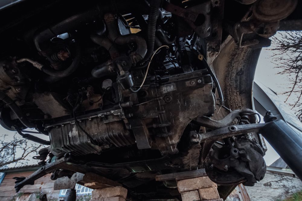 A Car Engine is Sitting on Top of a Pile of Bricks — Blackwall Tyre Service & Mechanical Repairs In Blackwall, NSW