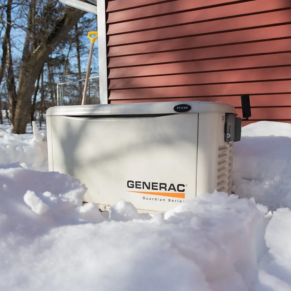 Un générateur Generac est assis dans la neige