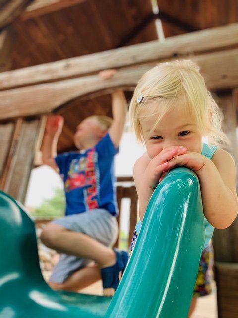 Smiling Kid On A Slide — Omaha, NE — Montessori Academy Of West Omaha