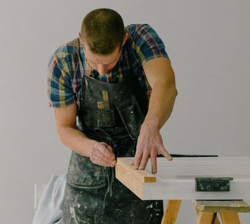 handyman working on door frame