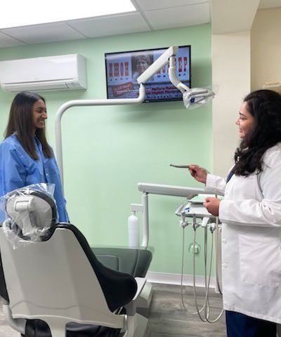 desk with computer and phone and chair with exit sign