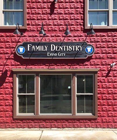 Family Dentistry Evans City logo on red building