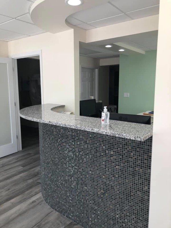 front desk in office with hand sanitizer on desk