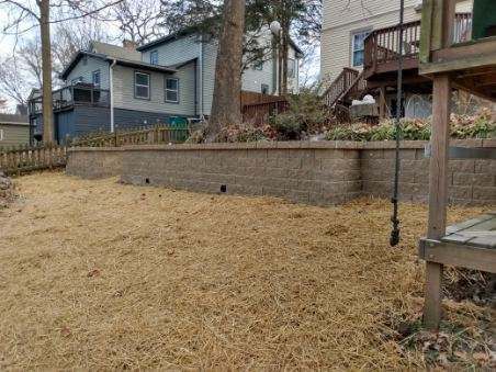 There is a swing in the backyard of a house.