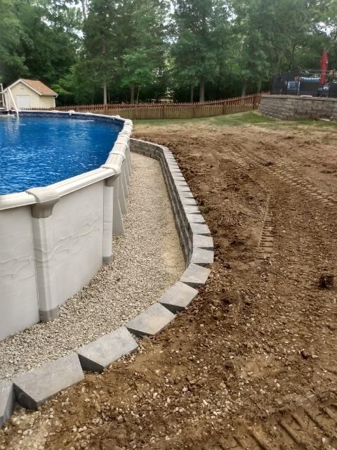 A swimming pool is being built in a backyard.