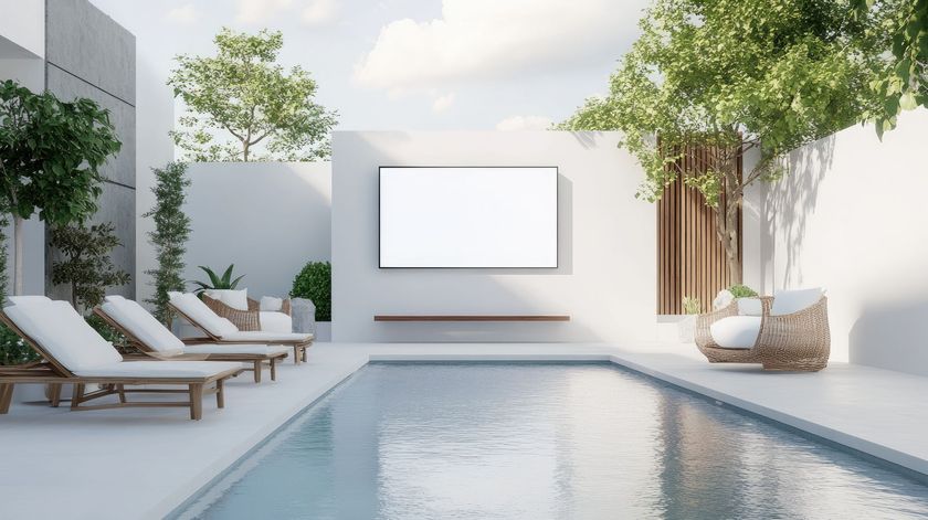 A swimming pool with a flat screen tv on the wall.