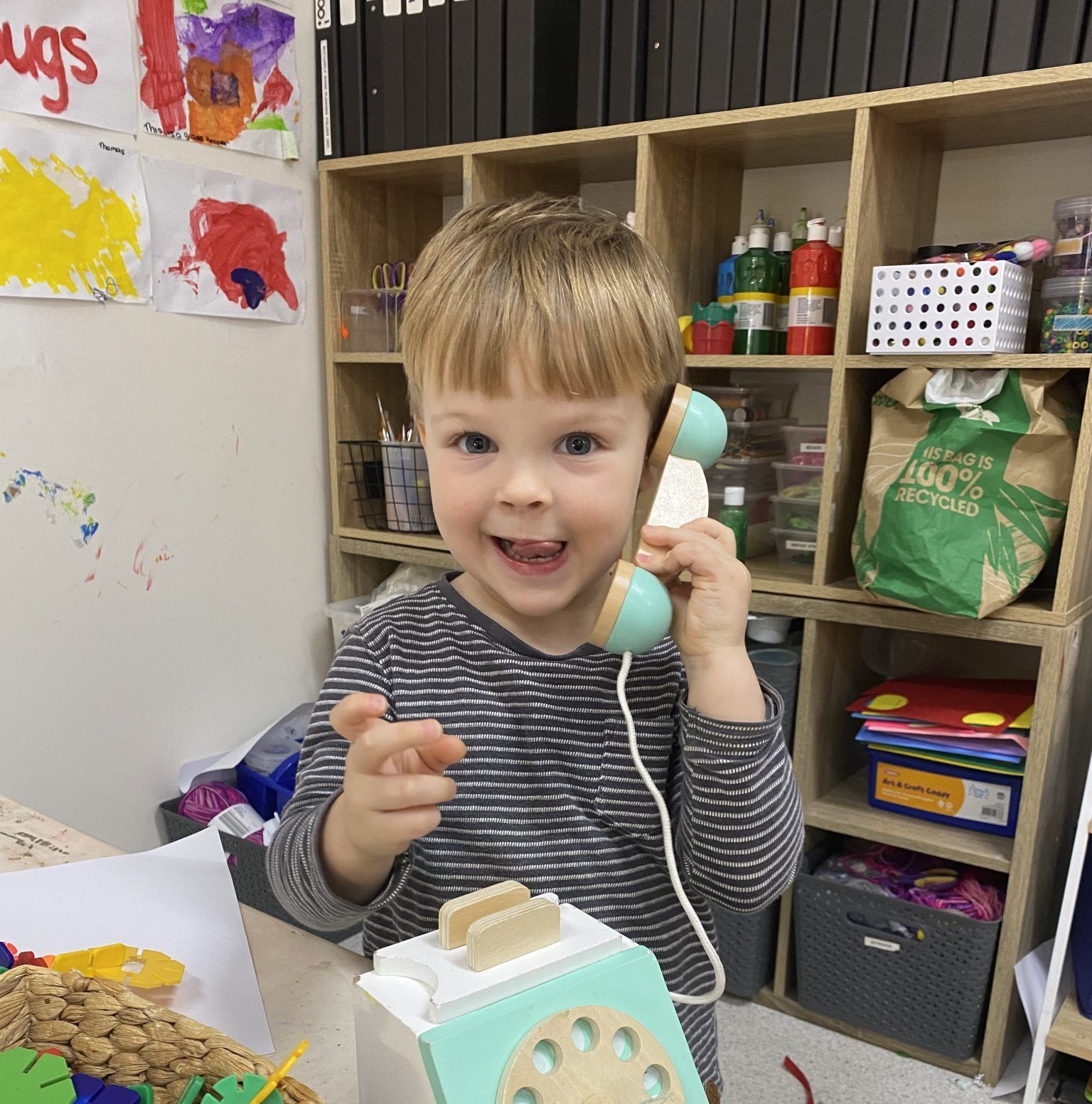 a child with a toy telephone