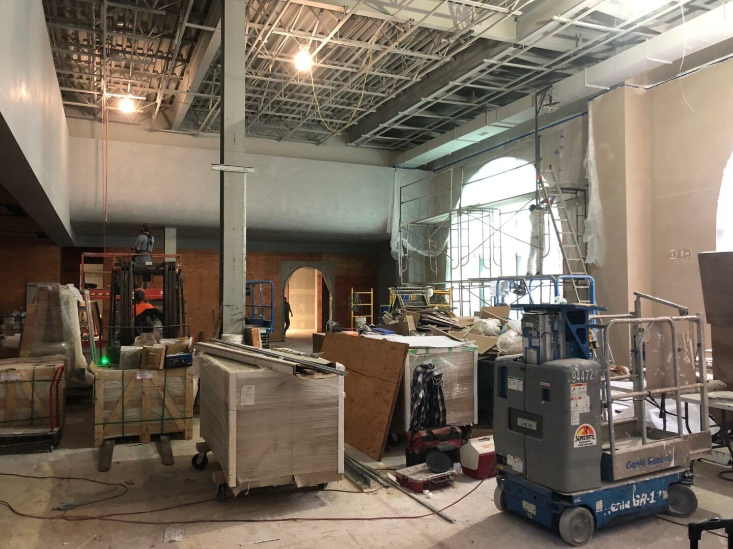 A large building under construction with a lot of machinery in it.