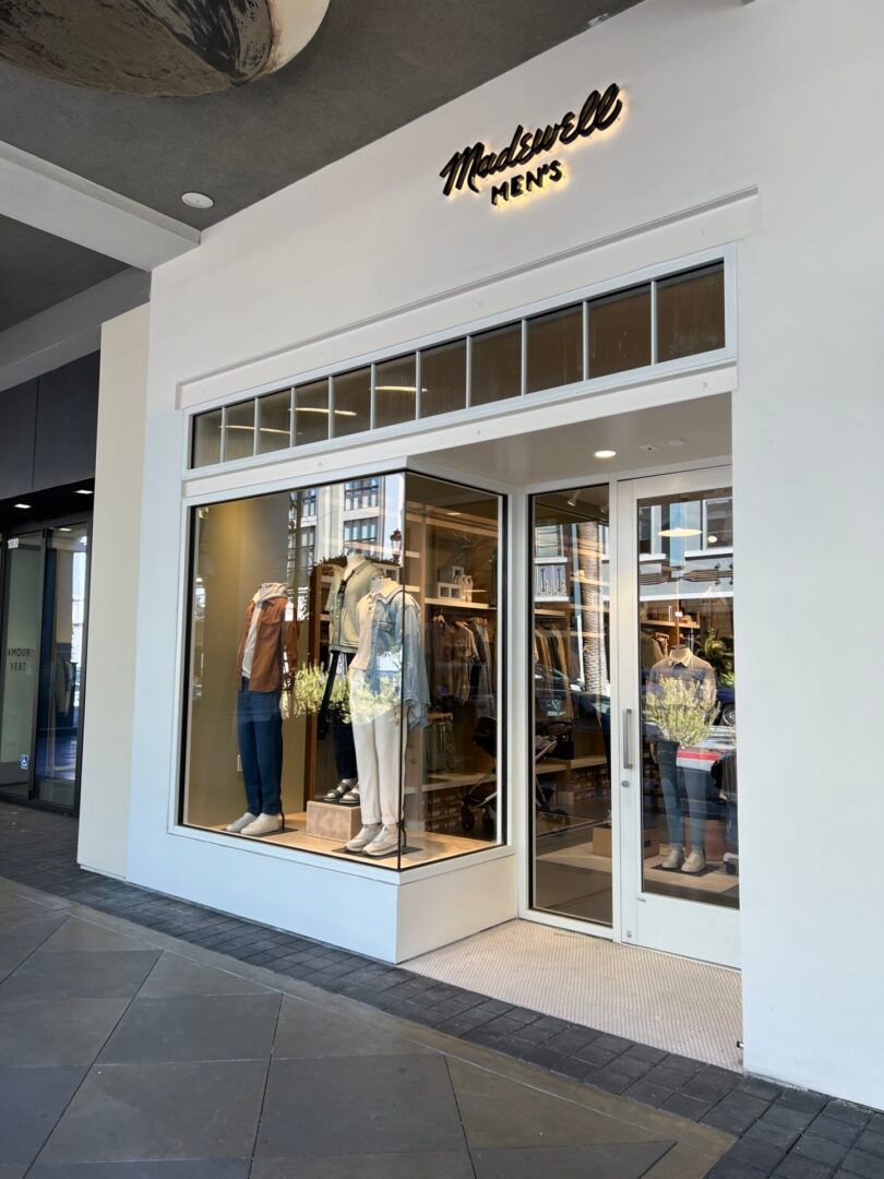 A store front with mannequins in the window.