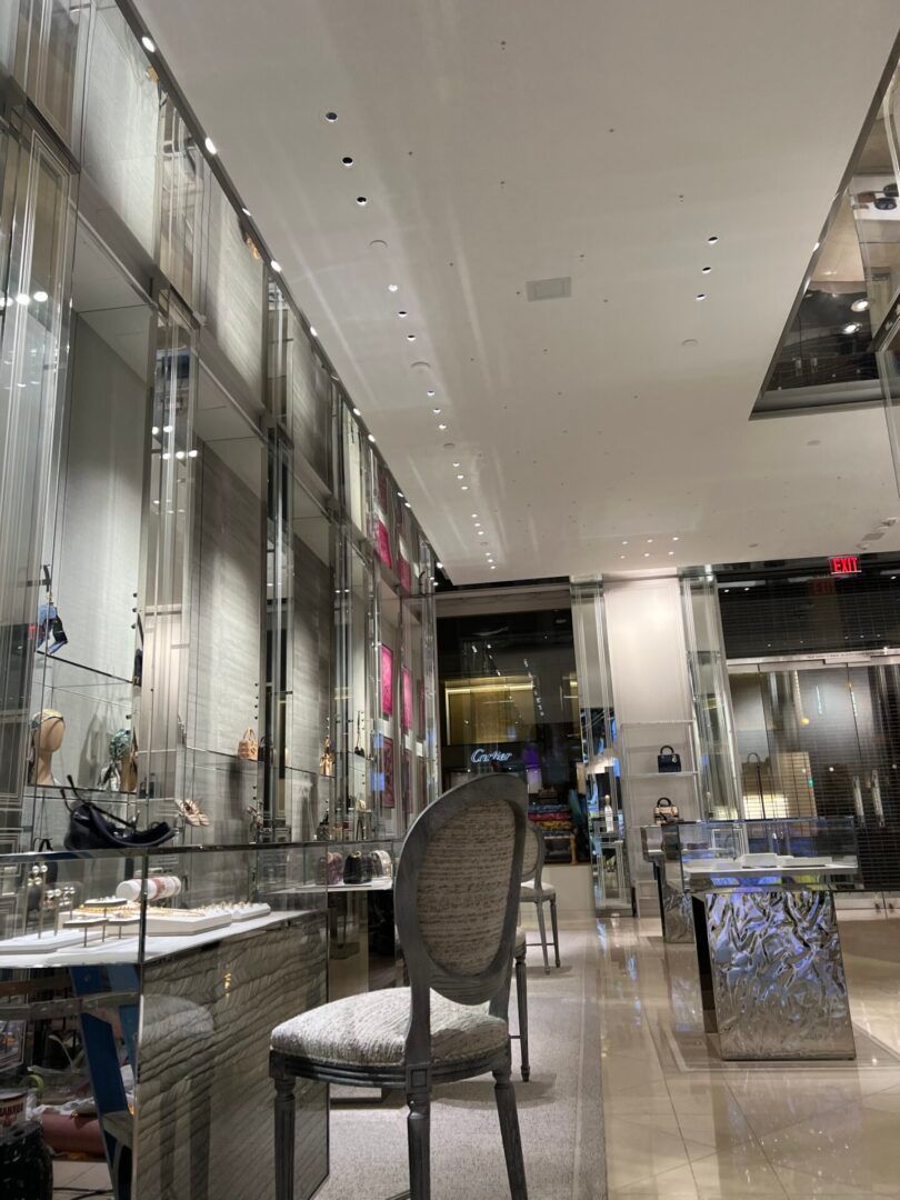 A chair is sitting in the middle of a large room in a store.