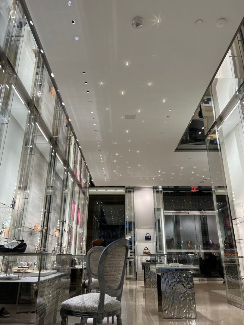 A very long room with a lot of lights on the ceiling.