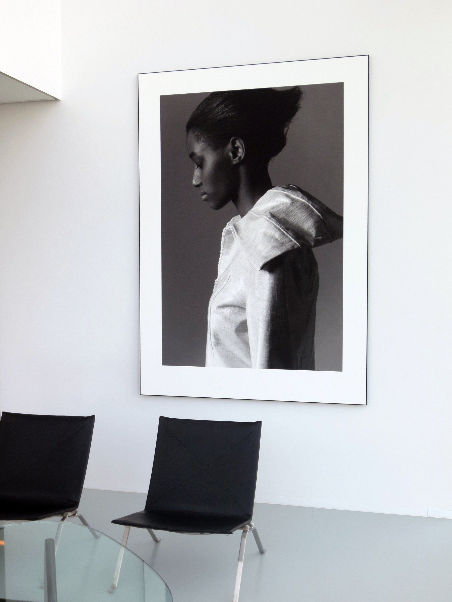 A black and white photo of a woman hanging on a wall
