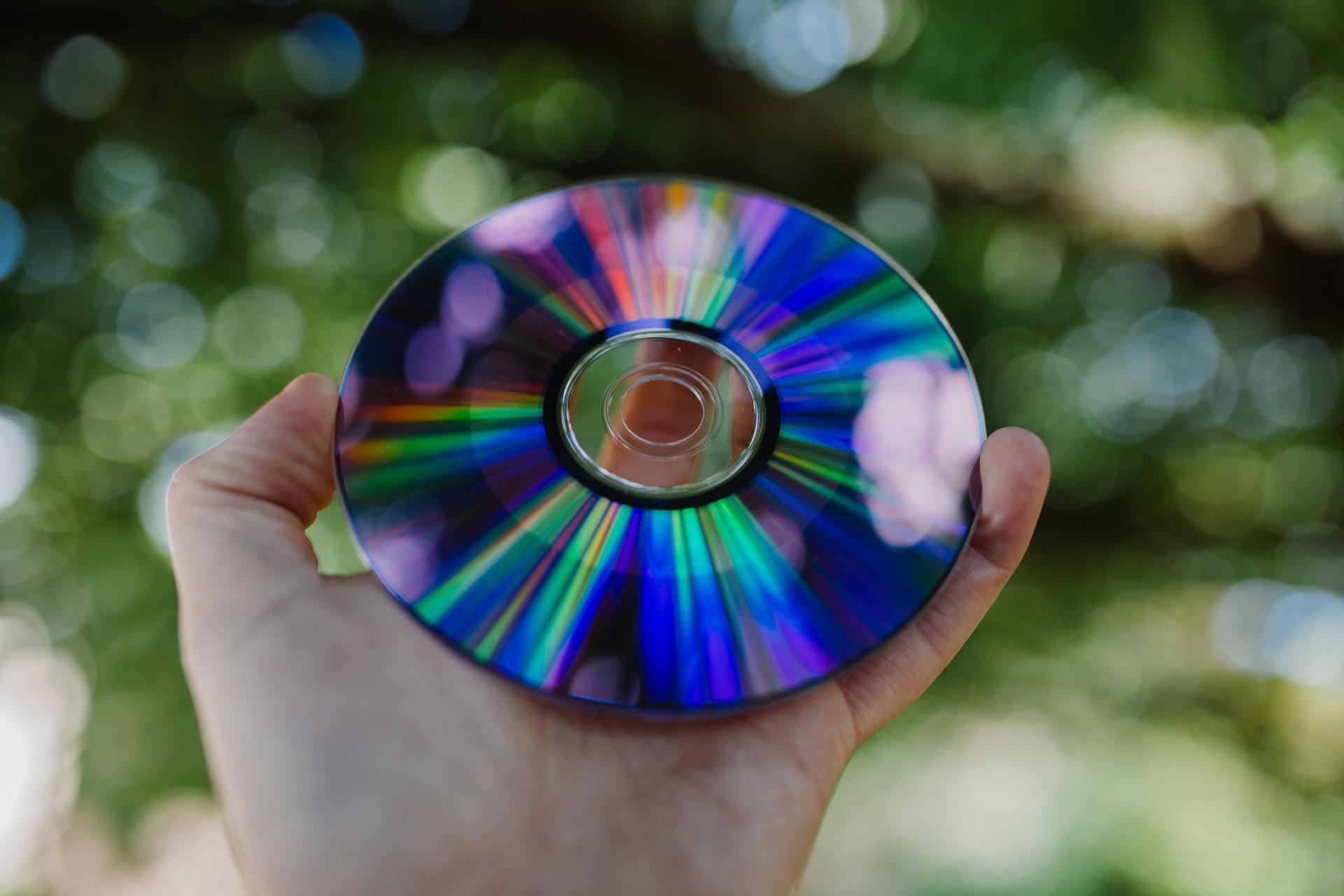 A person is holding a cd in their hand.