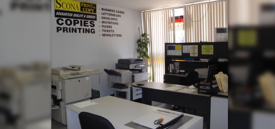 A office with a sign that says copies printing on it