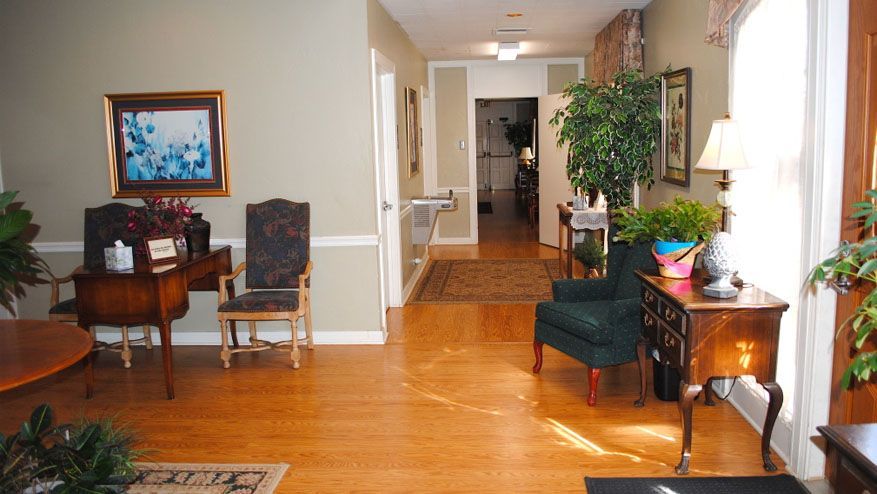 a living room with hardwood floors and a painting on the wall