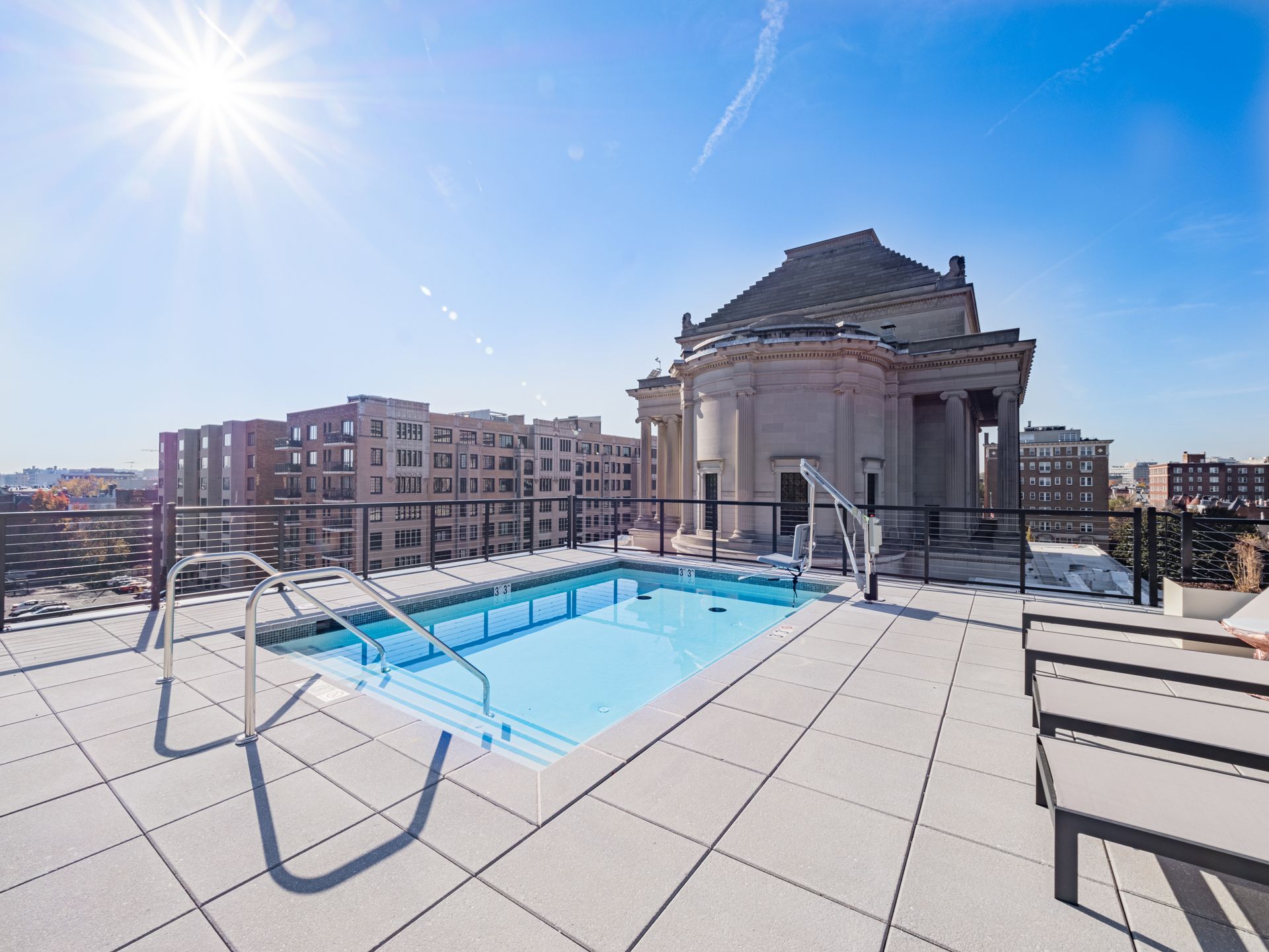 A large building with a swimming pool in front of it