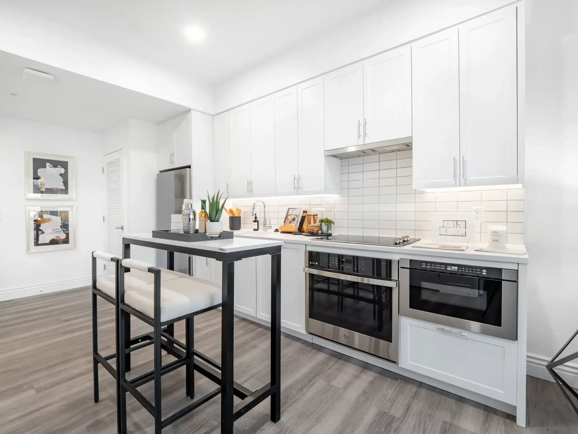A kitchen with white cabinets and stainless steel appliances