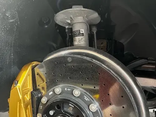 A close up of a brake disc on a car | Redline Automotive