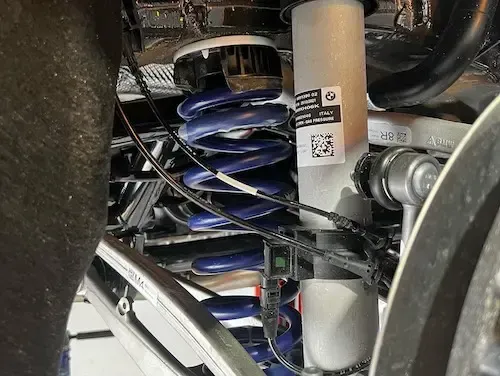 A close up of a shock absorber on a car | Redline Automotive