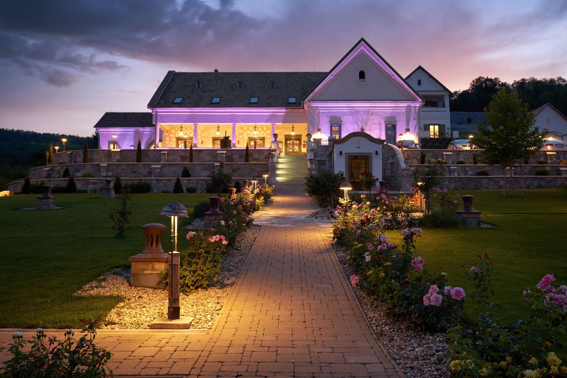 A large house is lit up with purple lights at night