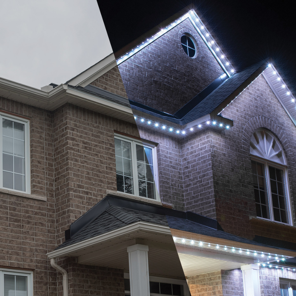 A brick house with a roof that is lit up at night