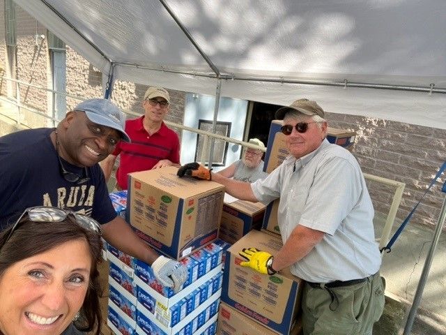 Unload food shipment for the Lord's Pantry