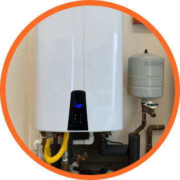 White tankless water heater with digital display and connected pipes.