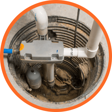 Sump pump in a circular concrete basin. Gray pump, white pipes, and a blue water line are visible.