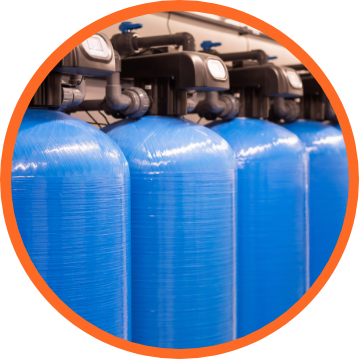 Row of blue water filtration tanks in a circular orange frame.