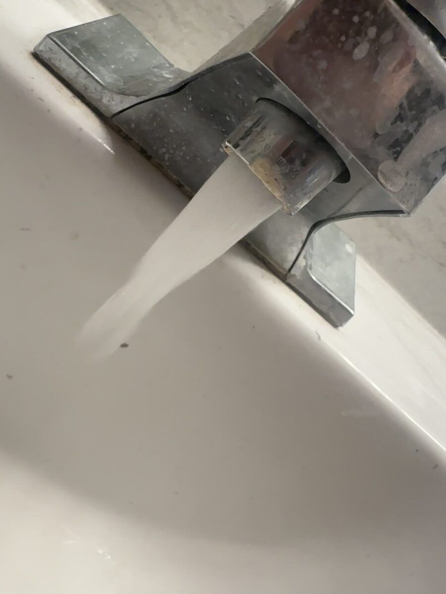 White hard-water scale crusted on a bathroom faucet in a Utah home