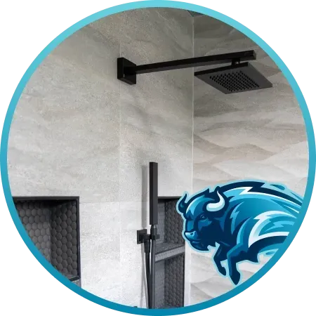 Black showerhead, faucet, and built-in shelves in a shower with gray stone walls. Blue buffalo logo in the corner.