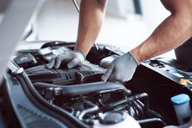 mechanic working on car engine