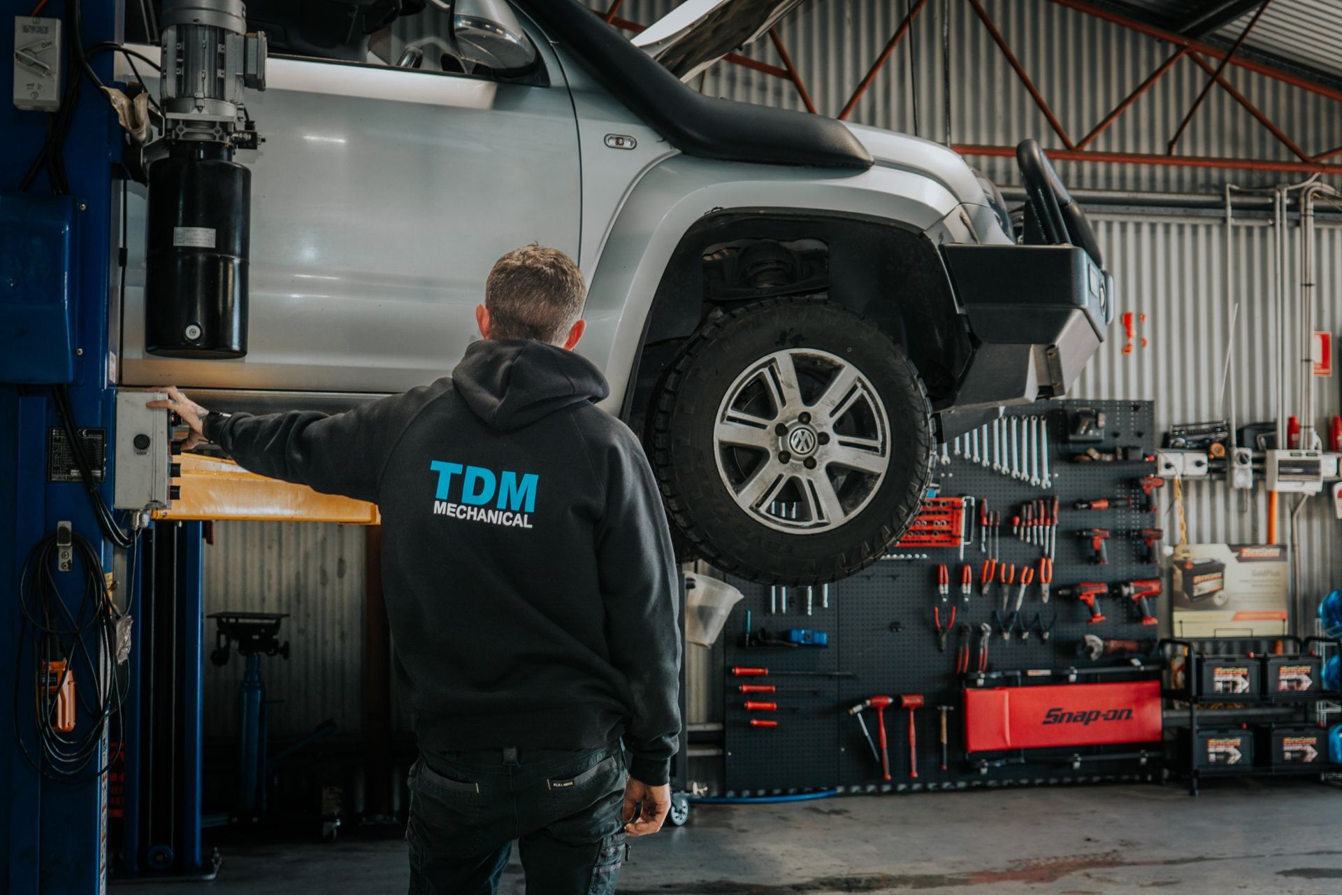 Mechanic inspecting suspension and steering