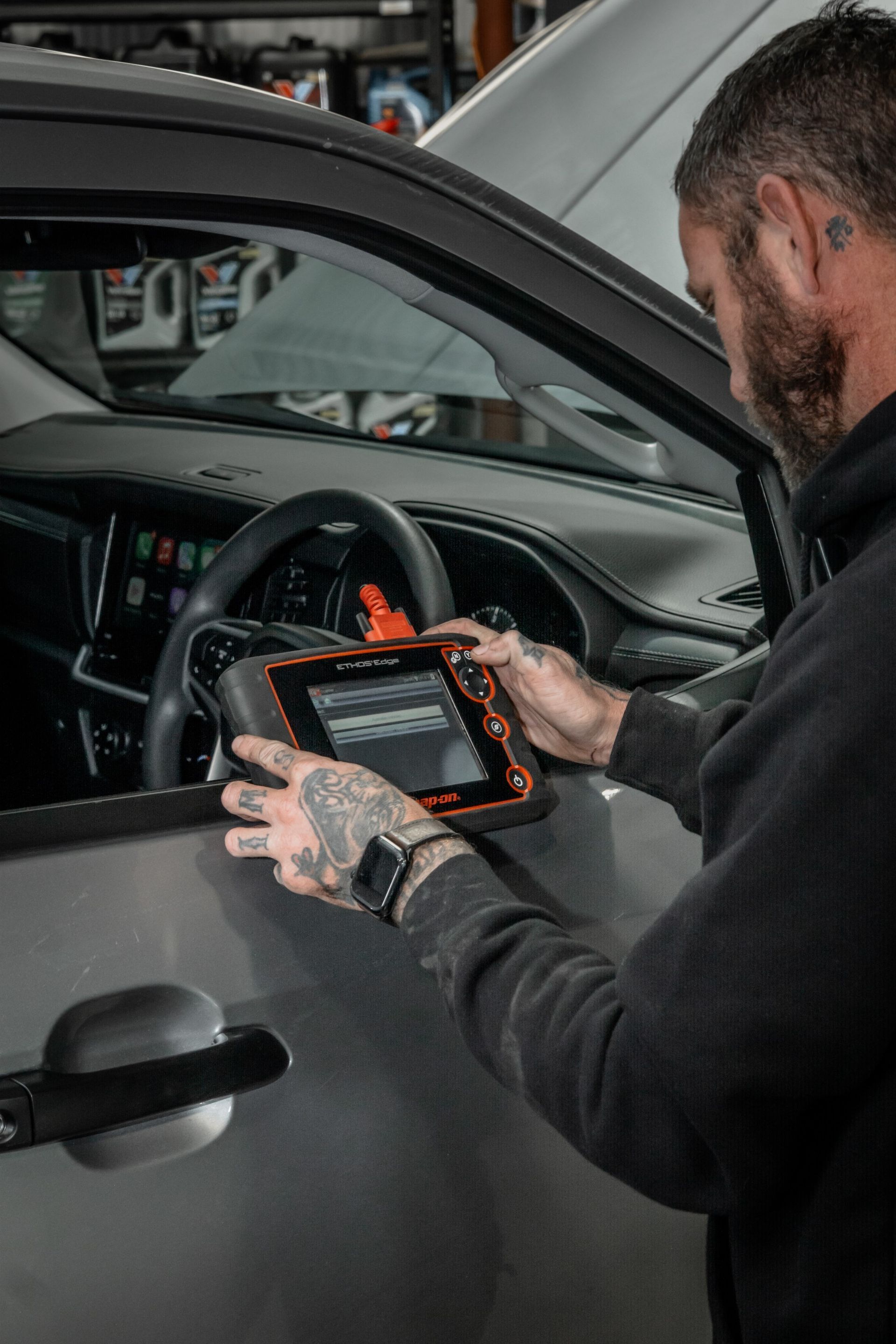 A mechanic testing with top notch technology a car's performance