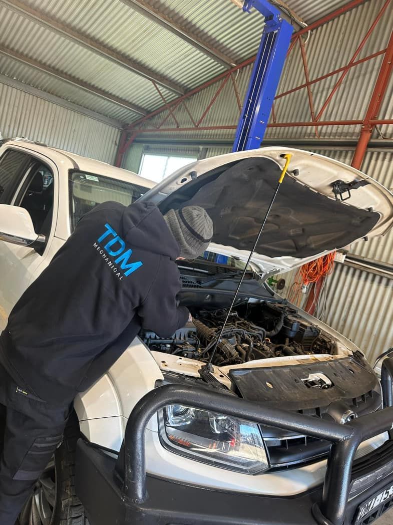 Mechanic Inspecting Engine Bay of a White SUV — Tom Duggan Mechanical in Dubbo, NSW