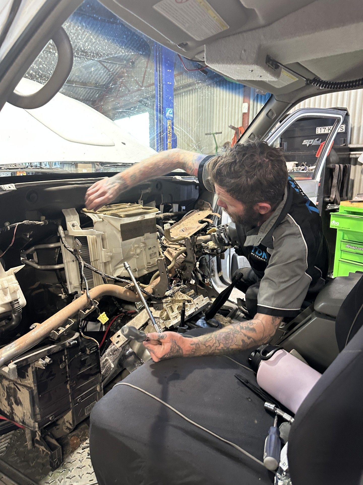 A Close Up of a Car Suspension With a Tire in the Background — Tom Duggan Mechanical in Dubbo, NSW