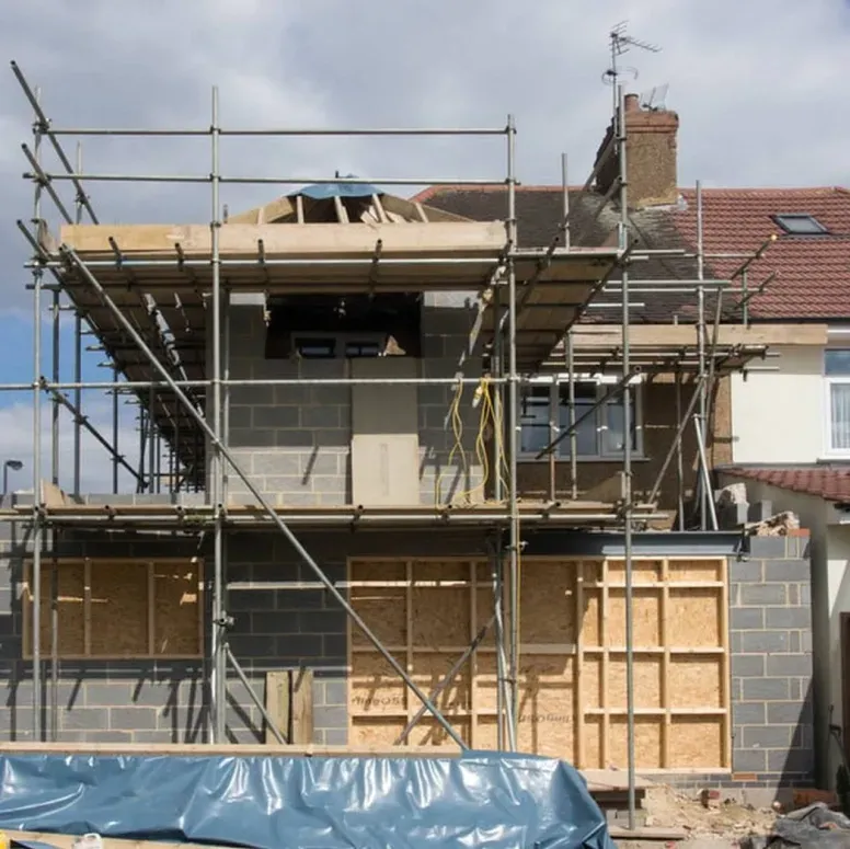 A house under construction with scaffolding around it