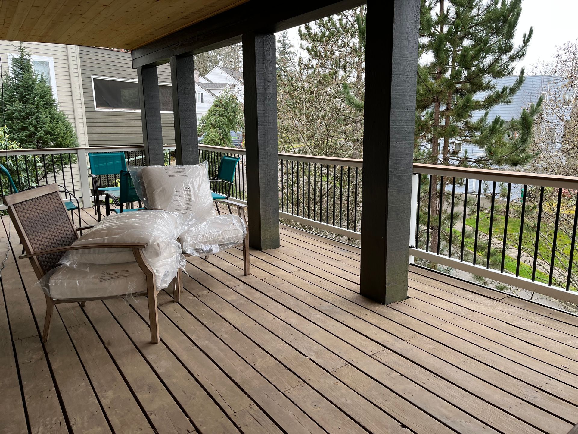 A wooden deck with a chair and a table on it