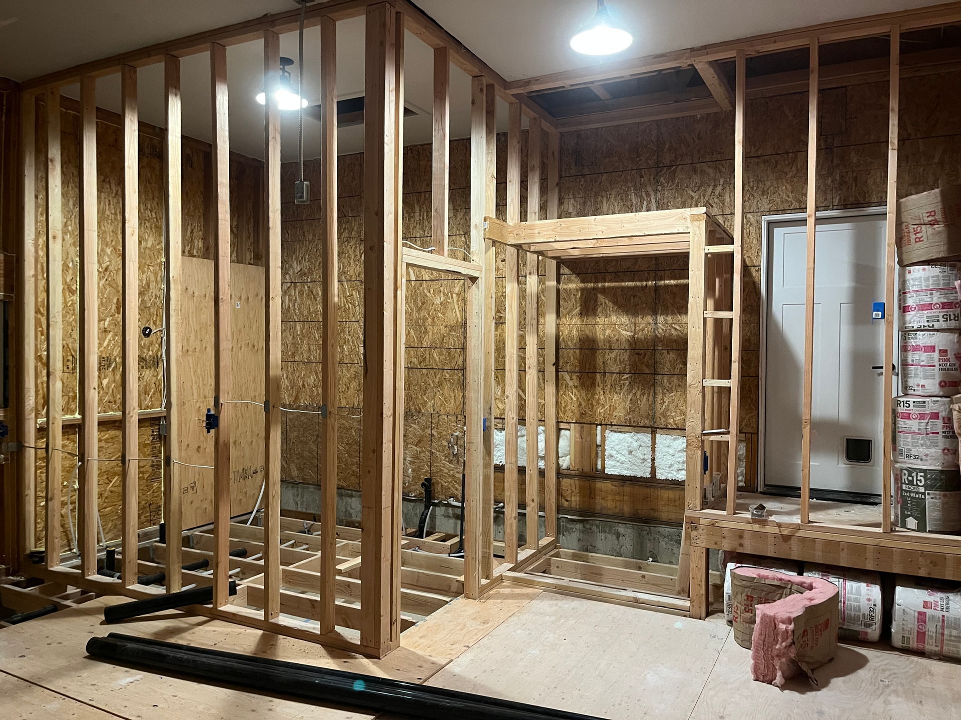 A room is being built with wooden beams and a door.