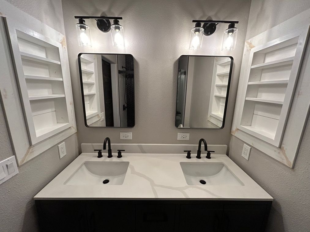 A bathroom with two sinks and two mirrors.