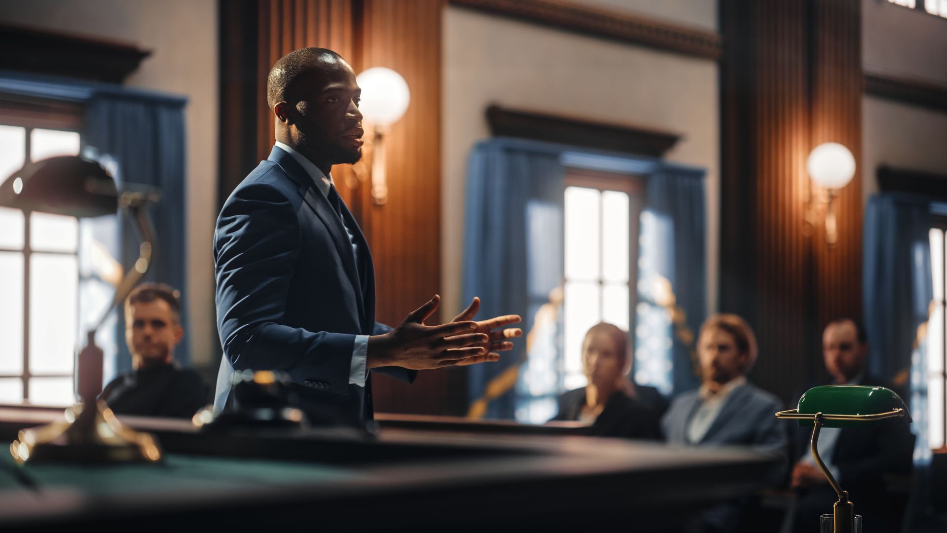 A man speaking in front of a courtroom