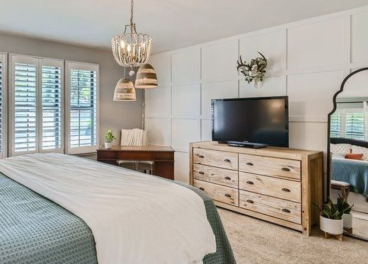 After interior design of Master Bedroom with custom square board and batten. Modern decor.